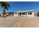 Newly renovated single-story home with a large driveway and landscaped yard at 7272 W College Dr, Phoenix, AZ 85033