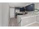 Modern kitchen with dark cabinetry, marble countertops, and stainless steel appliances at 7272 W College Dr, Phoenix, AZ 85033