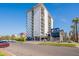 Exterior view of a tall, white apartment building with parking and landscaping at 805 N 4Th Ave # 101, Phoenix, AZ 85003