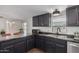 Updated kitchen featuring dark cabinets, stainless steel appliances, and a granite-look countertop at 8832 E Pueblo Ave # 16, Mesa, AZ 85208