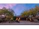 Two-story home with a tile roof, desert landscaping, and a two-car garage at sunset at 9472 E Whitewing Dr, Scottsdale, AZ 85262