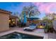 Tranquil pool with fire pit, lounge chairs, and desert landscaping at 9472 E Whitewing Dr, Scottsdale, AZ 85262