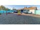 Spacious backyard with gravel, hammock, hot tub, and covered patio at 10443 W Butler Dr, Peoria, AZ 85345