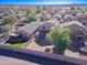 Aerial view of house, backyard, and neighborhood; trampoline visible at 10856 E Arcadia Ave, Mesa, AZ 85208