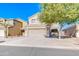 Two-story house with a tan facade and a two-car garage at 10856 E Arcadia Ave, Mesa, AZ 85208