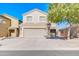 Two-story house with a tan facade and a two-car garage at 10856 E Arcadia Ave, Mesa, AZ 85208