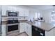 Well-equipped kitchen with stainless steel appliances and white cabinetry at 10856 E Arcadia Ave, Mesa, AZ 85208