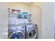 Well-lit laundry room complete with washer and dryer at 10856 E Arcadia Ave, Mesa, AZ 85208