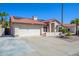 Single-story home with tile roof, solar panels, and a two-car garage at 11316 W Willow Ln, Avondale, AZ 85392