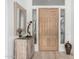 Light and bright entryway with a wooden door and console table at 12776 N 114Th St, Scottsdale, AZ 85259