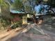 Brick pathway leads to a private backyard with mature trees and a wooden fence at 1325 E Avalon Dr, Phoenix, AZ 85014