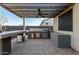 Outdoor kitchen with stainless steel appliances under a pergola at 16233 S 178Th Dr, Goodyear, AZ 85338