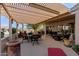 Spacious covered patio with seating area and desert landscaping at 16502 W Arroyo Ct, Surprise, AZ 85374