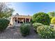 Backyard view of home with covered patio, desert landscaping and citrus trees at 16502 W Arroyo Ct, Surprise, AZ 85374