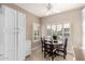 Kitchen breakfast nook with white cabinetry, tile flooring, and a small dining table at 16502 W Arroyo Ct, Surprise, AZ 85374