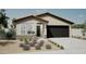 New single-story home with a two-car garage and desert landscaping at 18131 W Sand Hills Dr, Surprise, AZ 85387