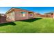 Large backyard with grassy area and home view at 18450 W Elwood St, Goodyear, AZ 85338