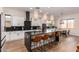 Modern kitchen with white cabinets, dark countertops, and island seating at 18450 W Elwood St, Goodyear, AZ 85338