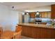 Eat-in kitchen with granite countertops and breakfast bar at 2326 E Aspen Dr, Tempe, AZ 85282