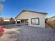 Backyard view showing the house exterior, gravel, and firepit at 25742 W Victory W St, Buckeye, AZ 85326