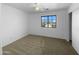 Bright bedroom featuring neutral carpeting and a window at 2605 W Gold Mine Way, San Tan Valley, AZ 85144