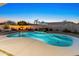 Backyard paradise with a pool, waterfall feature, and fire pit area at 30680 N 126Th Dr, Peoria, AZ 85383