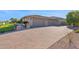 Home exterior showcasing a three-car garage and paved driveway at 3331 E Indigo Cir, Mesa, AZ 85213