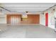 Garage with built-in storage and red door access at 3331 E Indigo Cir, Mesa, AZ 85213