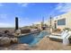 Inviting pool with a spa, outdoor seating, and a stunning desert view at 35037 N El Sendero Rd, Carefree, AZ 85377