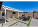 Relaxing patio area with pergola, comfortable seating, and a TV at 4035 E Indianola Ave, Phoenix, AZ 85018