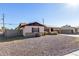 Single story home with solar panels and a gravel front yard at 4415 N 79Th Dr, Phoenix, AZ 85033