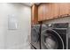 Laundry room with Samsung washer and dryer, wood cabinets at 6525 E Cave Creek Rd # 9, Cave Creek, AZ 85331