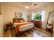 Cozy bedroom with hardwood floors, mid-century modern furniture and large window at 741 E Mountain Sage Dr, Phoenix, AZ 85048