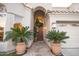 Inviting entryway with a wooden door and large potted plants at 741 E Mountain Sage Dr, Phoenix, AZ 85048