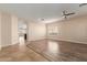 Spacious living room with wood-look tile flooring and a ceiling fan at 8371 W Pontiac Dr, Peoria, AZ 85382