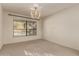 Dining room with chandelier, window overlooking pool, and carpet flooring at 12276 E Cortez Dr, Scottsdale, AZ 85259