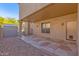 Covered patio with a unique geometric tile design and pet door at 12276 E Cortez Dr, Scottsdale, AZ 85259