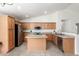 Kitchen with island, granite counters, and wood cabinets at 12510 W Tonto St, Avondale, AZ 85323