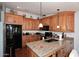 Kitchen with wood cabinets, granite counters, and black appliances at 13854 N Fountain Hills Blvd, Fountain Hills, AZ 85268