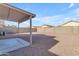 Large backyard with covered patio and gravel landscaping at 14834 W Calavar Rd, Surprise, AZ 85379