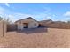 Spacious backyard with covered patio and gravel at 14834 W Calavar Rd, Surprise, AZ 85379