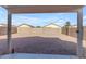 Large gravel backyard with block wall and covered patio at 14834 W Calavar Rd, Surprise, AZ 85379