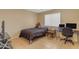 Cozy bedroom with a double bed, workspace, and tiled floors at 14834 W Calavar Rd, Surprise, AZ 85379