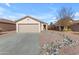 Single-story home with a two-car garage and rock landscaping at 14834 W Calavar Rd, Surprise, AZ 85379