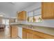 Clean kitchen features wood cabinets, stainless steel appliances, and a double sink at 14834 W Calavar Rd, Surprise, AZ 85379