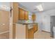 Kitchen with light wood cabinets and double sink at 14834 W Calavar Rd, Surprise, AZ 85379