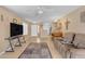 Living room with tiled floors and a large TV at 14834 W Calavar Rd, Surprise, AZ 85379