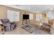 Living room with tiled floors and a large TV at 14834 W Calavar Rd, Surprise, AZ 85379