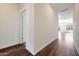 Bright hallway with wood-look flooring and access to other rooms at 18103 W Sand Hills Dr, Surprise, AZ 85387