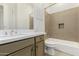 Bathroom with tub, toilet and vanity with quartz countertop at 18394 N 97Th Pl, Scottsdale, AZ 85255